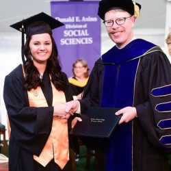 Girl shaking hands with college president