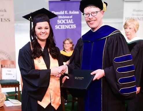 Girl shaking hands with college president