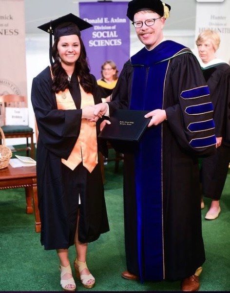 Girl shaking hands with college president