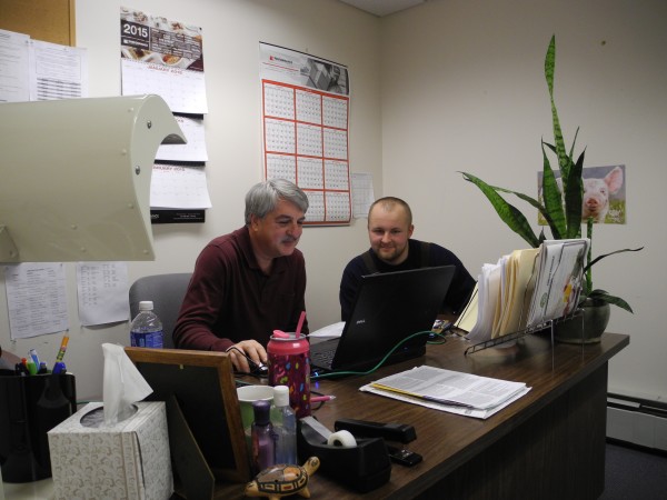 Two men sitting at a computer