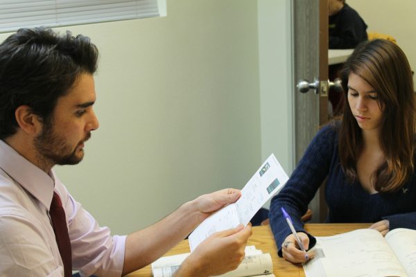 A man and women studying at a table.