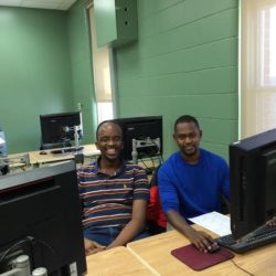 Two men sitting at a computer
