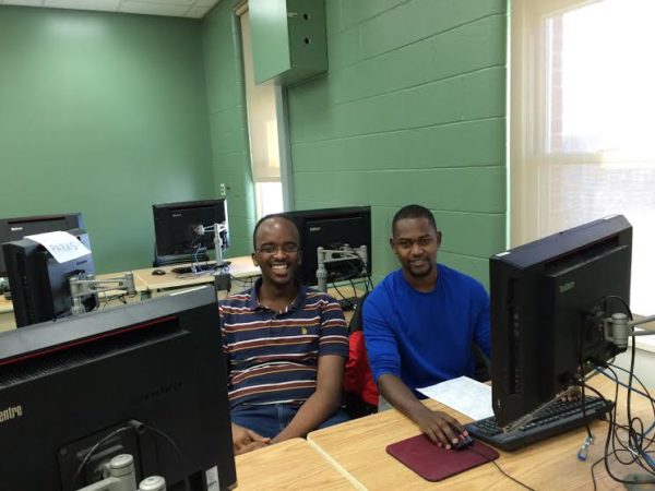 Two men sitting at a computer