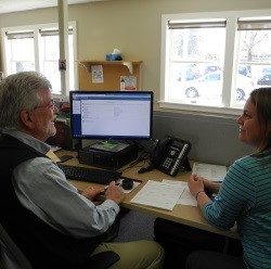 Man helping woman with tax return.