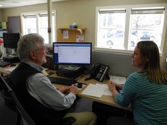 Man helping woman with tax return.