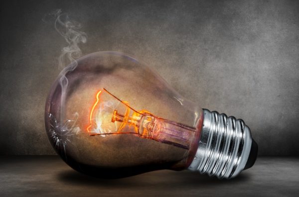 Light bulb with smoke coming out of it.