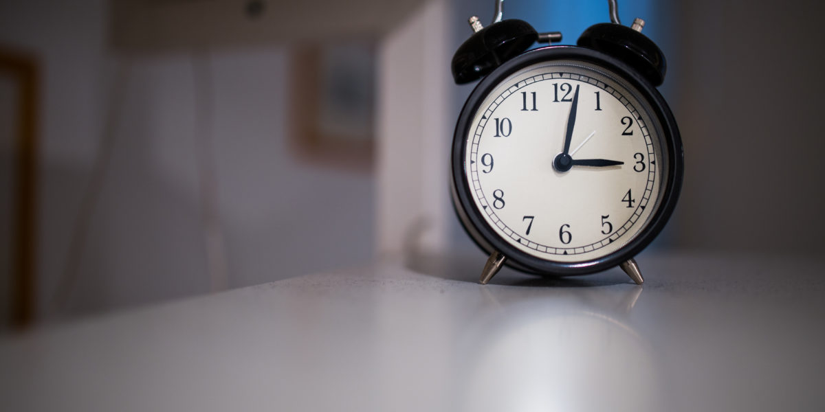 Clock sitting on white table.