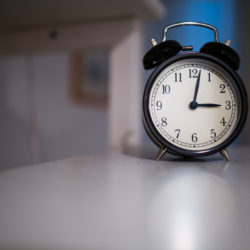 Clock sitting on white table.