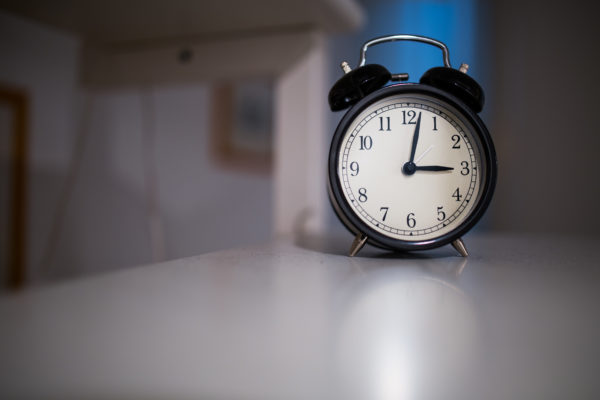 Clock sitting on white table.