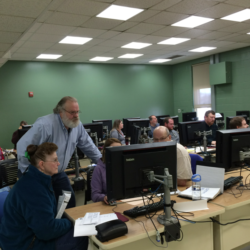 Tax preparers and tax filers looking at computer screen