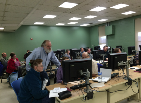 Tax preparers and tax filers looking at computer screen