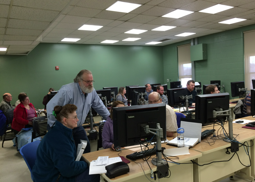 Tax preparers and tax filers looking at computer screen