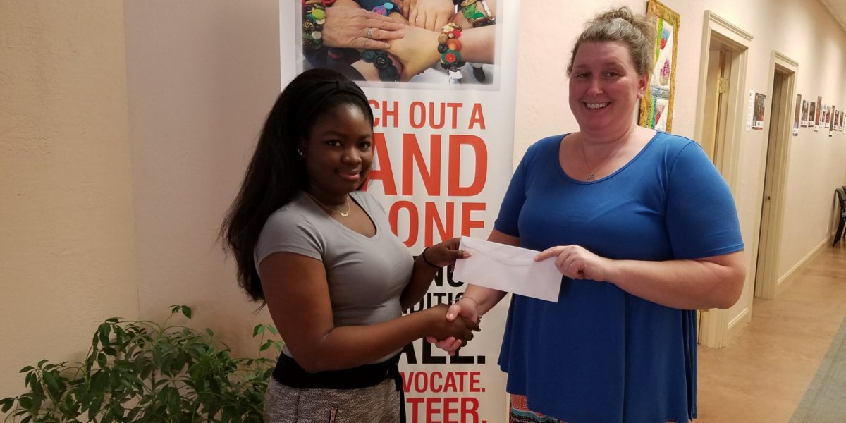 Student receiving scholarship from woman at United Way