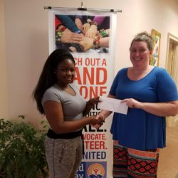 Student receiving scholarship from woman at United Way