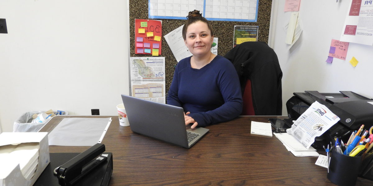 Santa Havener sitting at her desk at work