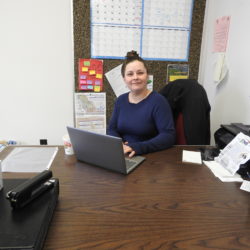 Santa Havener sitting at her desk at work