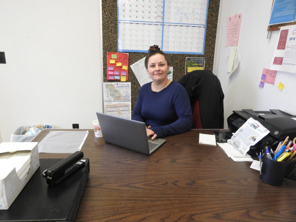 Santa Havener sitting at her desk at work