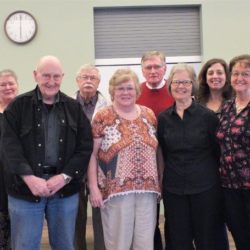 Men and Women standing together, facing the camera for a posed group photo.