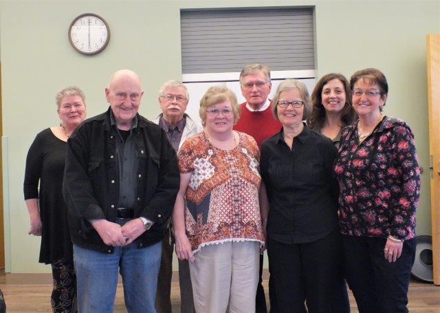 Men and Women standing together, facing the camera for a posed group photo.