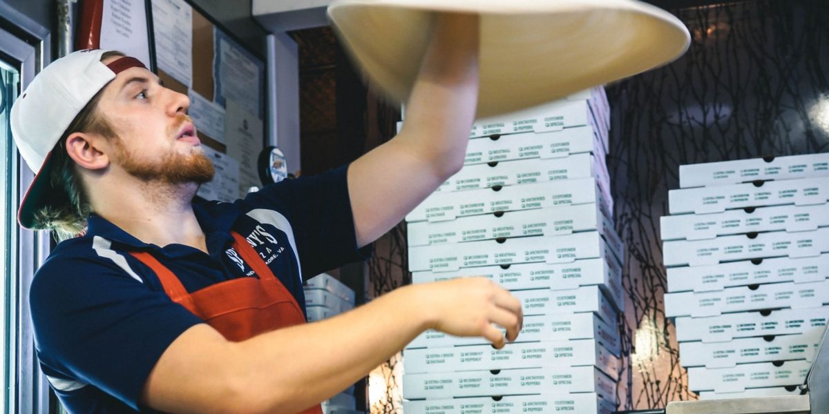 Man tossing pizza dough