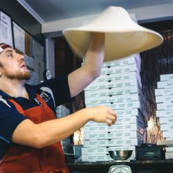 Man tossing pizza dough