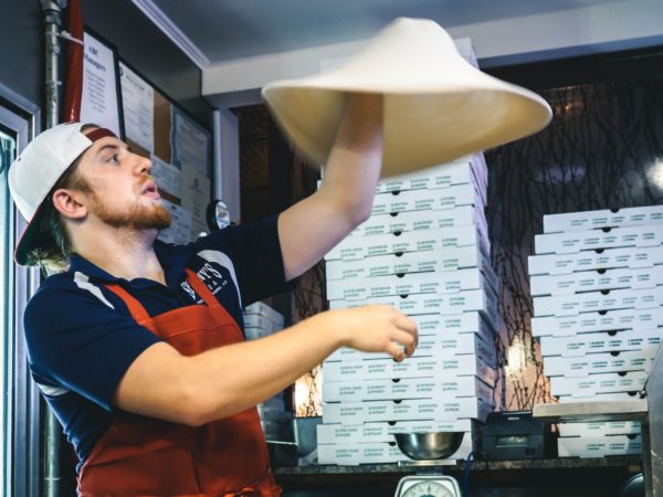 Man tossing pizza dough