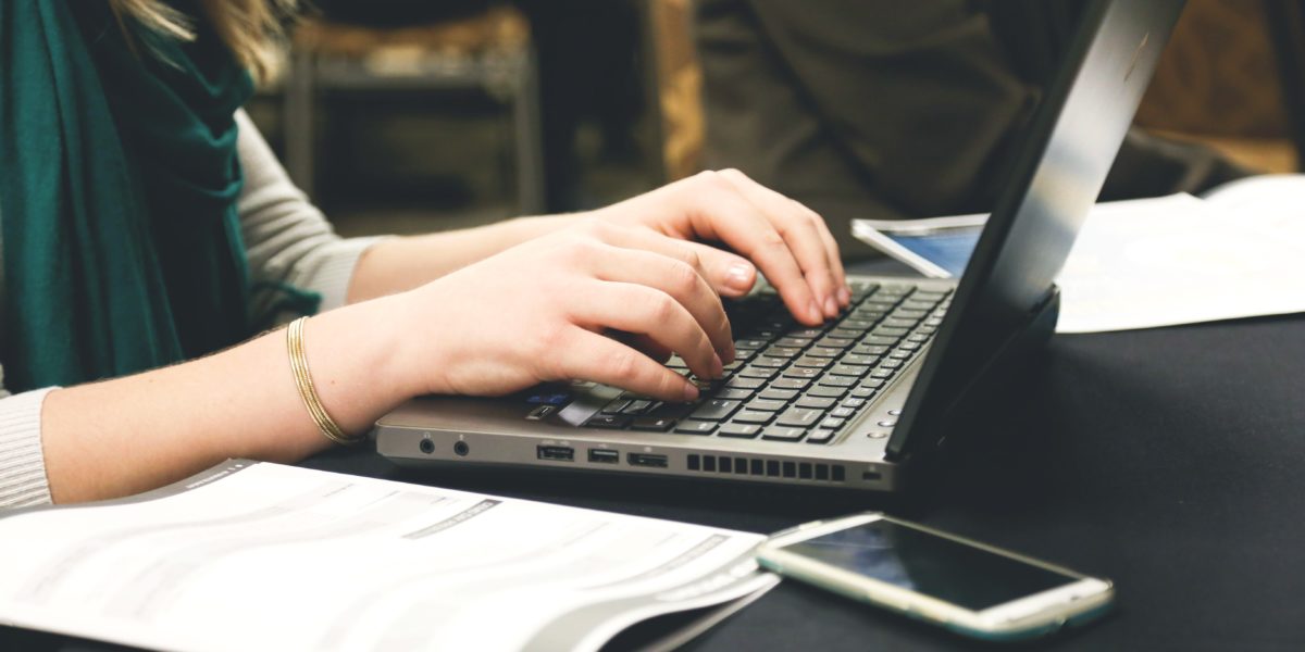 Woman's hands typing on laptop computer