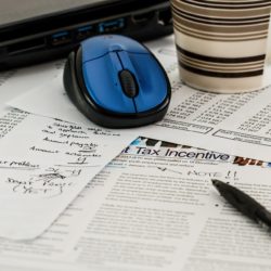 tax forms with pen and computer mouse