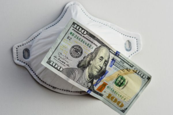 100 dollar bill and a medical mask