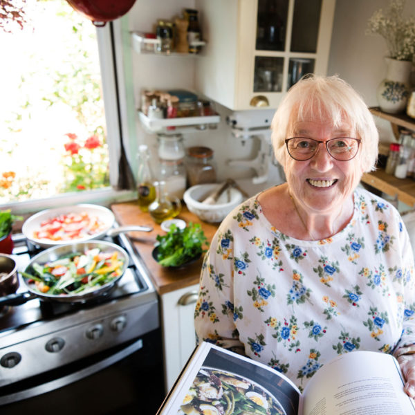 photo of woman cooking in her kitchen