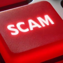 red button with white writing that says SCAM