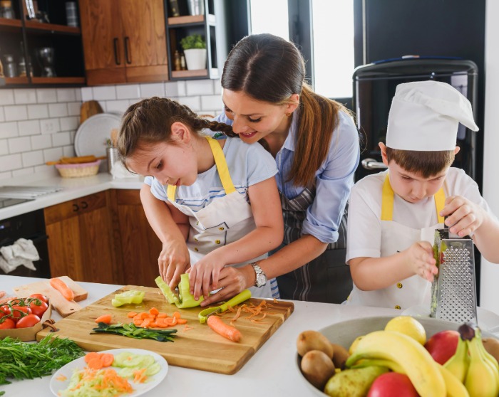 mother and kids cooking in their kitchen
