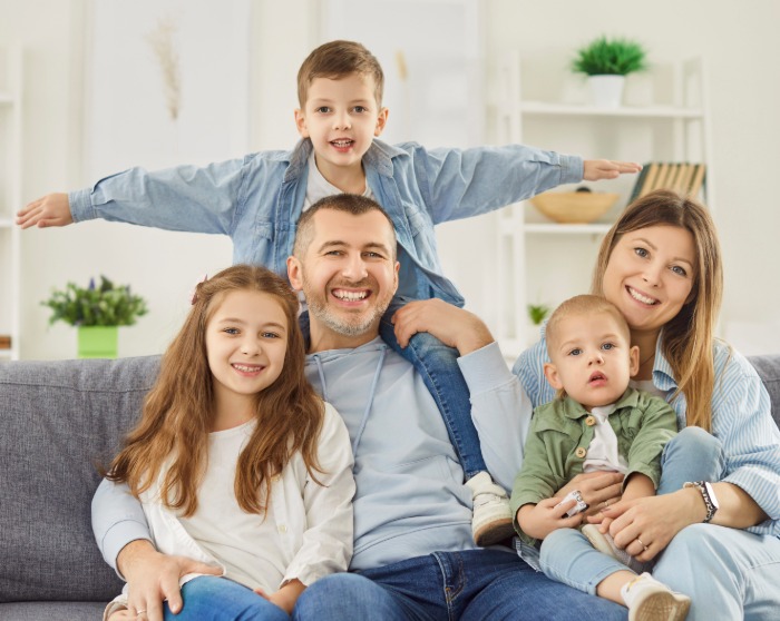family of five siitting on their couch