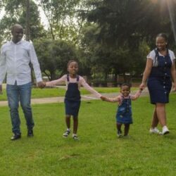 family of four walking through a park