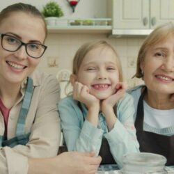 mom, daughter and granddaughter in kitchen smiling