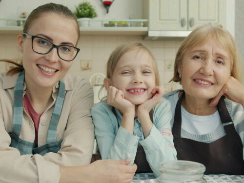 mom, daughter and granddaughter in kitchen smiling